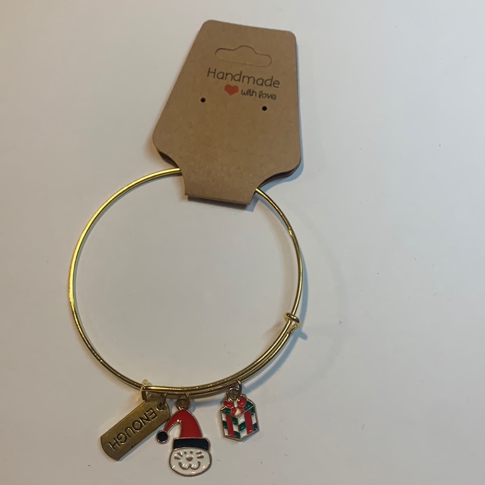 Handmade gold tone stainless steel bracelet with 3 charms.